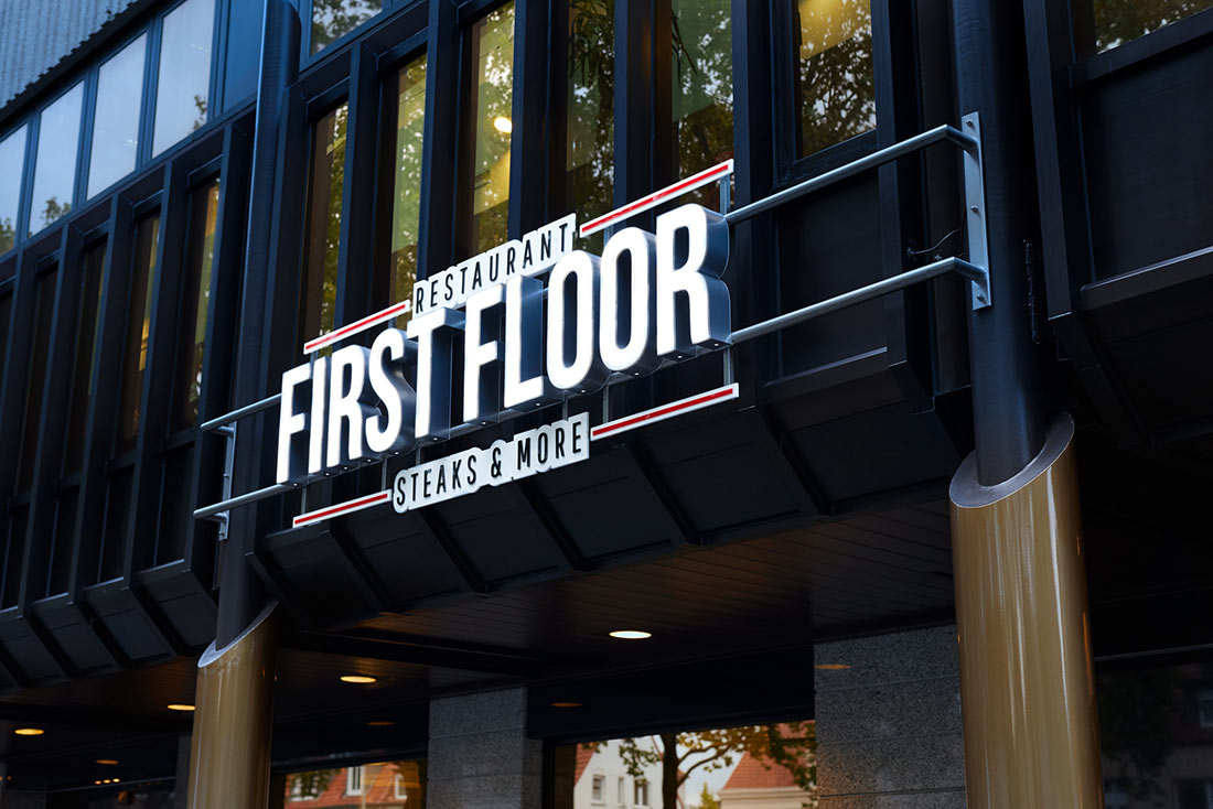 Close-up of the illuminated sign on the façade of the First Floor