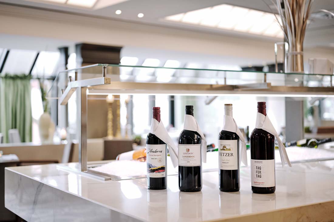 Restaurant with wine bottles in the foreground